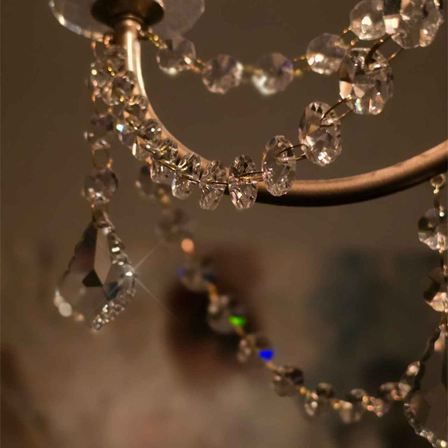 close up detail of an elegant crystal chandelier light fixture inside silhouette spa