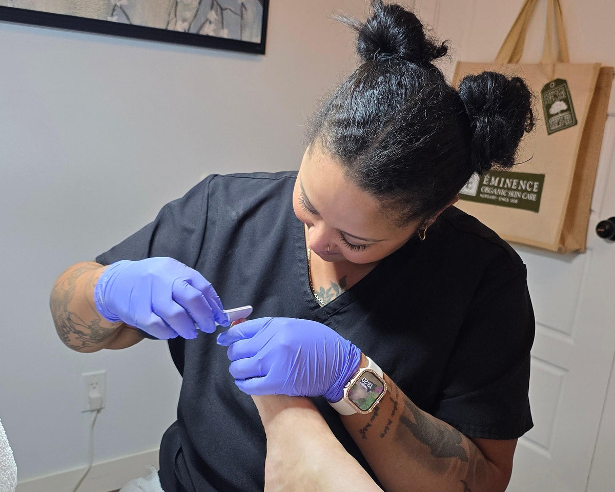 Niki performing a pedicure on a client